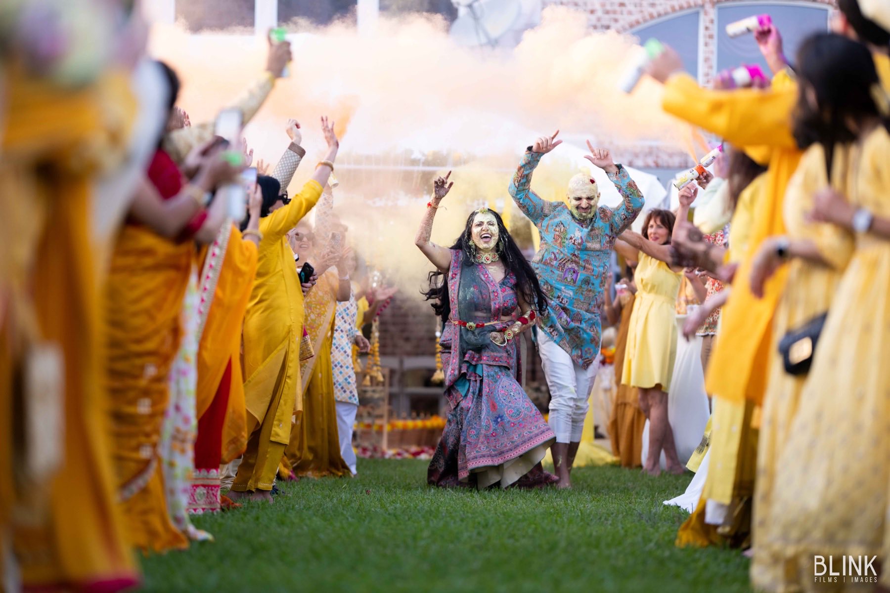 Joyful baraat entrance with coloured smoke
